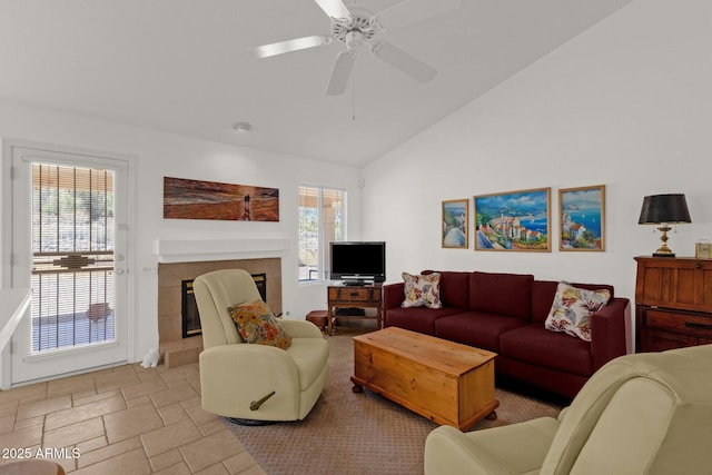 16002 E Gleneagle Dr, Fountain Hills, AZ 85268 - living area featuring vaulted ceiling, a tiled fireplace, a ceiling fan, and light stone finish flooring