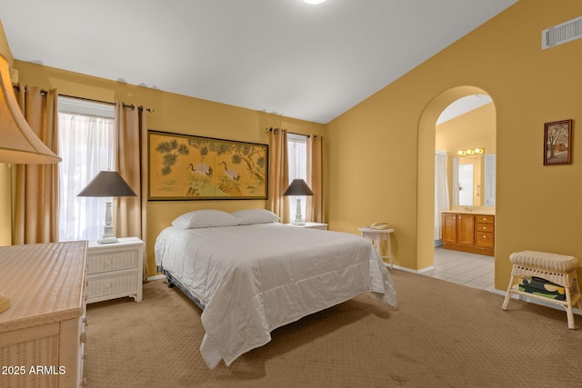 16002 E Gleneagle Dr, Fountain Hills, AZ 85268 - bedroom with vaulted ceiling, light carpet, arched walkways, connected bathroom, and baseboards