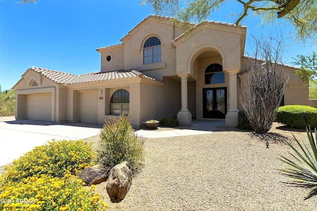 29771 N 67th St, Scottsdale, AZ 85266 - mediterranean / spanish home with concrete driveway, stucco siding, french doors, a tiled roof, and a garage