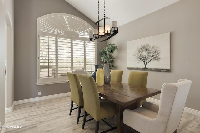 29771 N 67th St, Scottsdale, AZ 85266 - dining space with baseboards, lofted ceiling, wood finished floors, and an inviting chandelier