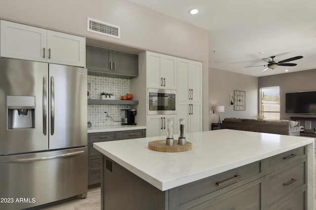 29771 N 67th St, Scottsdale, AZ 85266 - kitchen featuring gray cabinets, tasteful backsplash, stainless steel appliances, visible vents, and ceiling fan