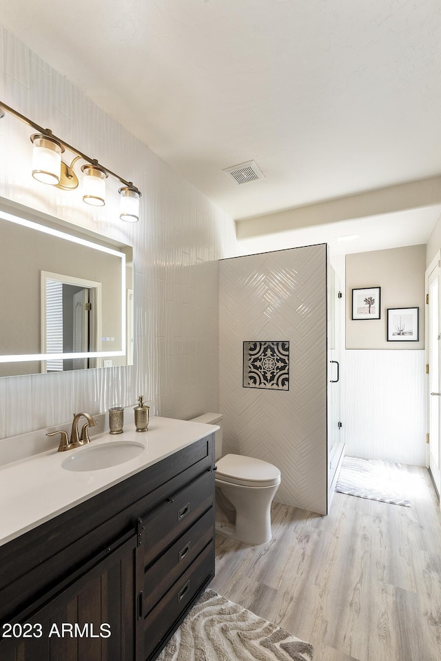 29771 N 67th St, Scottsdale, AZ 85266 - full bath featuring vanity, toilet, a stall shower, visible vents, and wood finished floors