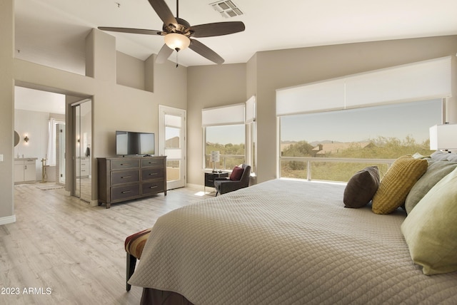 29771 N 67th St, Scottsdale, AZ 85266 - bedroom with a ceiling fan, baseboards, visible vents, light wood-style floors, and a towering ceiling