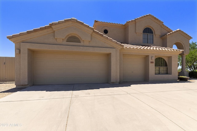 29771 N 67th St, Scottsdale, AZ 85266 - mediterranean / spanish-style house featuring a tile roof, concrete driveway, stucco siding, and an attached garage