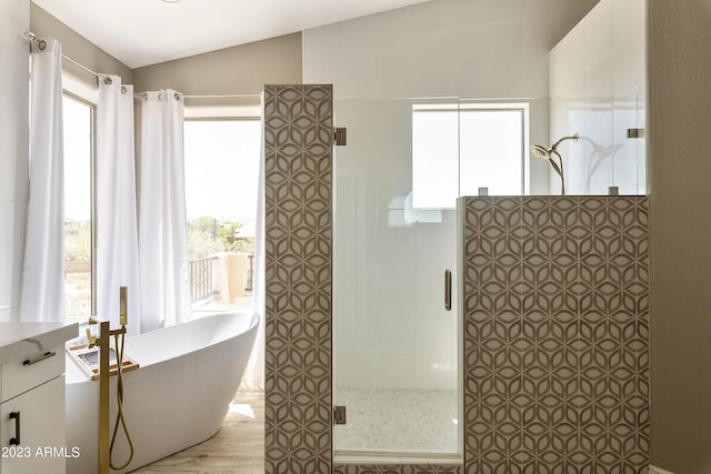29771 N 67th St, Scottsdale, AZ 85266 - bathroom featuring a soaking tub, a tile shower, wood finished floors, and lofted ceiling