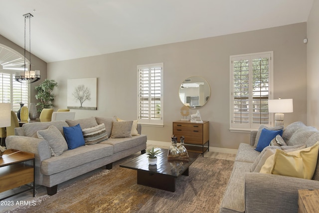 29771 N 67th St, Scottsdale, AZ 85266 - living area featuring an inviting chandelier, baseboards, lofted ceiling, and wood finished floors