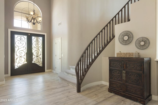 29771 N 67th St, Scottsdale, AZ 85266 - foyer entrance featuring french doors, stairway, a chandelier, wood finished floors, and visible vents
