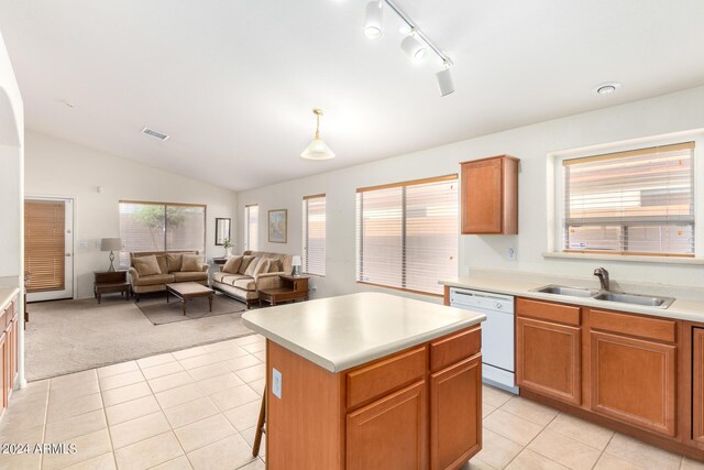 kitchen featuring sink, dishwasher, rail lighting, vaulted ceiling, and a kitchen island