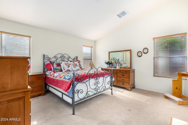 carpeted bedroom with vaulted ceiling