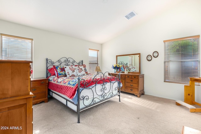 bedroom with light carpet and vaulted ceiling