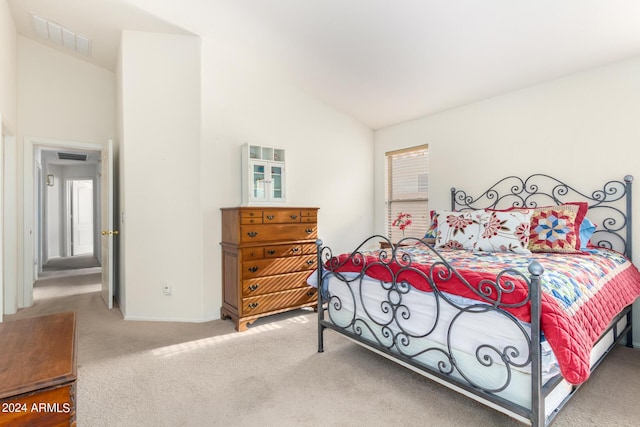 bedroom featuring vaulted ceiling and carpet