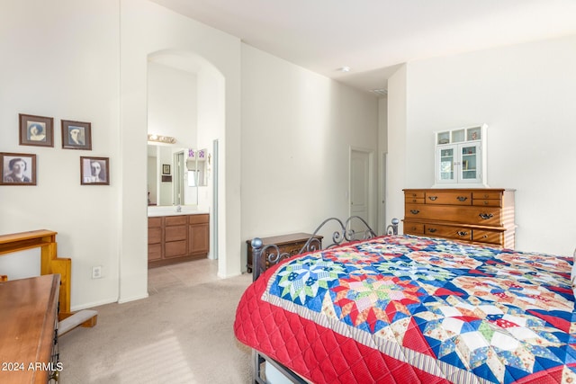 carpeted bedroom featuring ensuite bathroom