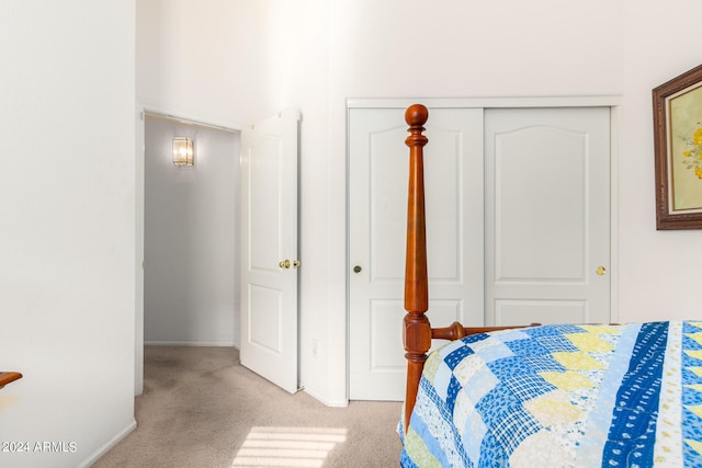 bedroom featuring light carpet and a closet