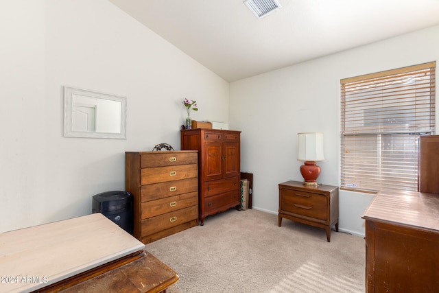 carpeted bedroom with lofted ceiling