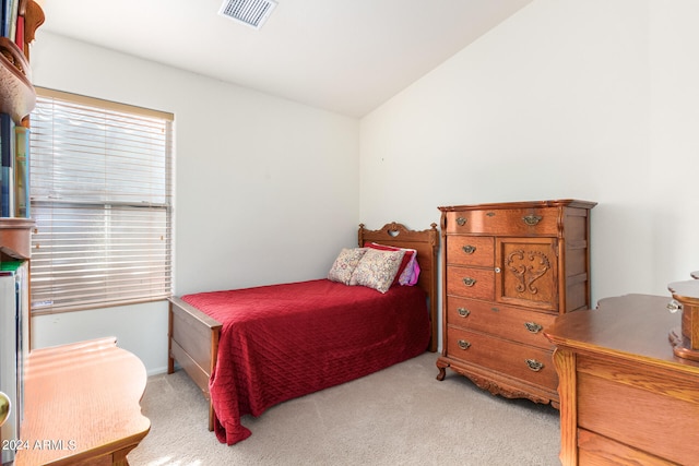 bedroom featuring lofted ceiling and light carpet