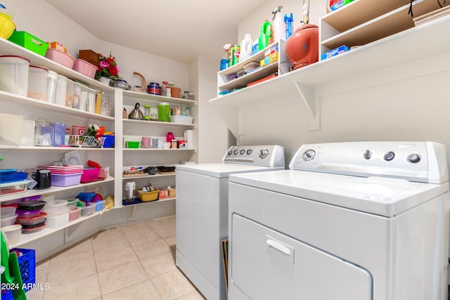 laundry room featuring washing machine and clothes dryer and light tile patterned floors