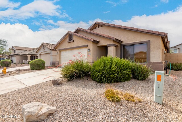 view of front of property with central AC and a garage