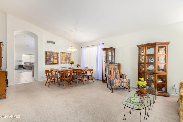 carpeted dining room featuring vaulted ceiling and a notable chandelier