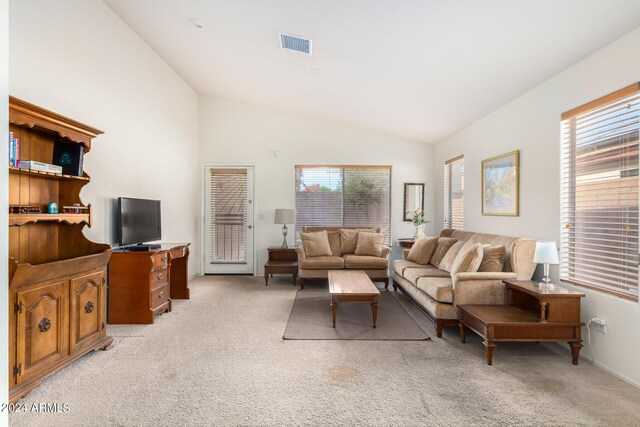 living room with vaulted ceiling and light carpet