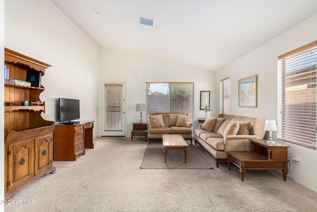 carpeted living room featuring high vaulted ceiling