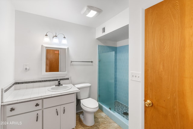 full bathroom featuring toilet, a stall shower, visible vents, and vanity