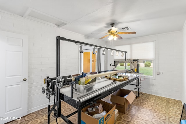 dining area with ceiling fan, brick wall, and visible vents