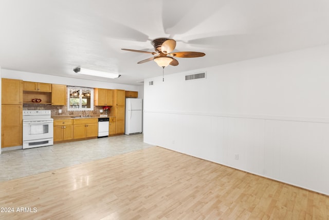 kitchen with white appliances, light tile patterned floors, backsplash, sink, and ceiling fan