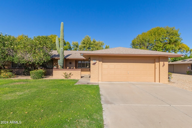 view of front of house featuring a garage and a front yard