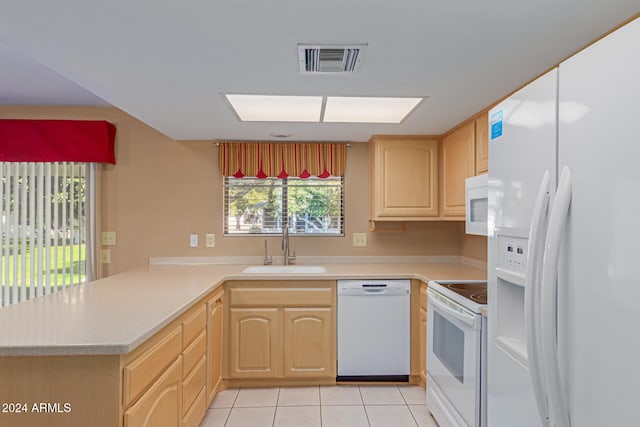 kitchen featuring sink, kitchen peninsula, white appliances, light brown cabinetry, and light tile patterned flooring