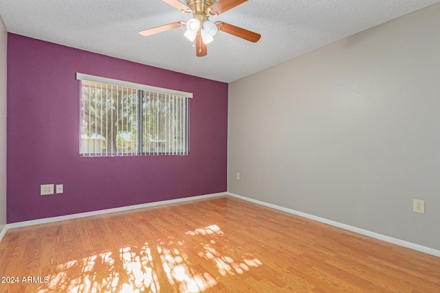 unfurnished room featuring a textured ceiling, light hardwood / wood-style flooring, and ceiling fan