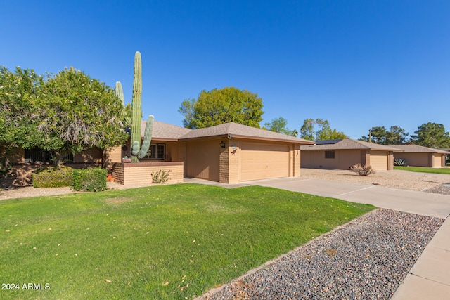 ranch-style house featuring a front yard and a garage