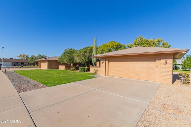 view of front of home with a garage and a front lawn