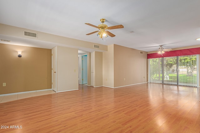 unfurnished room featuring light wood-type flooring and ceiling fan