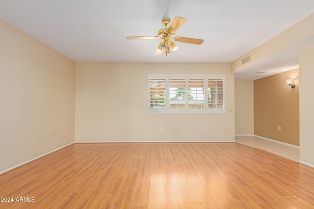 spare room featuring ceiling fan and light hardwood / wood-style flooring