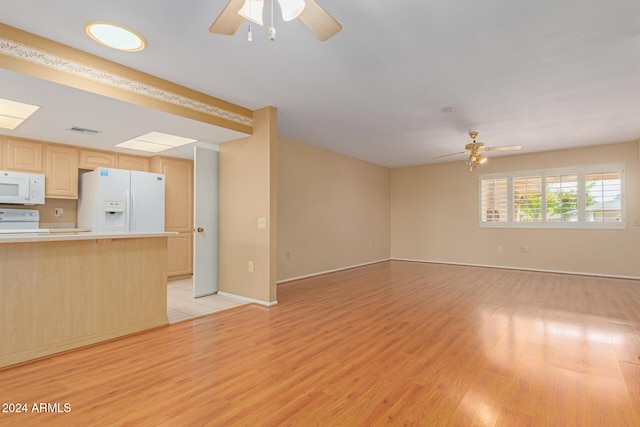 unfurnished living room featuring ceiling fan and light hardwood / wood-style floors