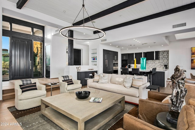 living room featuring wood-type flooring and beamed ceiling