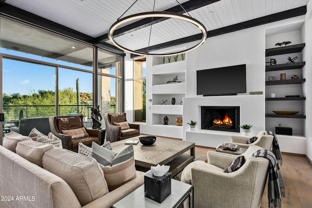 living room with built in shelves, hardwood / wood-style flooring, and wood ceiling