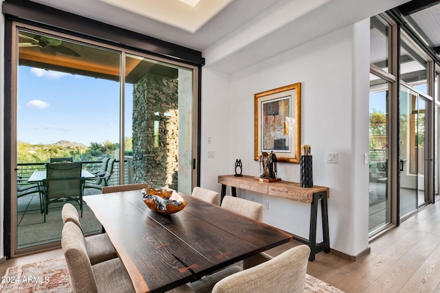 dining space featuring light wood-type flooring and a wealth of natural light