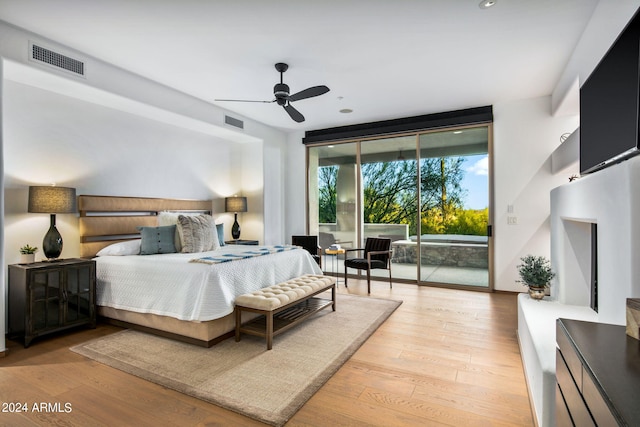 bedroom with access to outside, light hardwood / wood-style floors, and ceiling fan