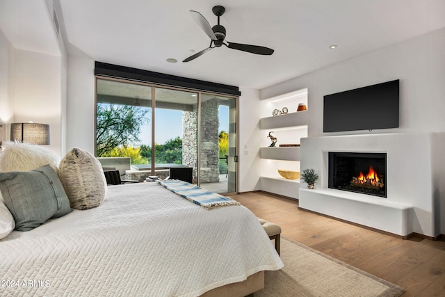 bedroom featuring ceiling fan, hardwood / wood-style floors, and access to exterior