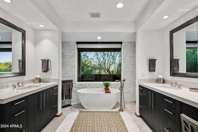 bathroom featuring vanity and a tub