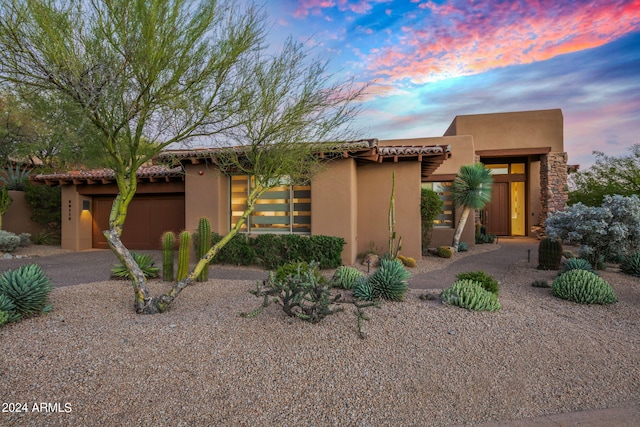 southwest-style home with a garage