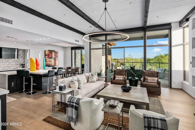 living room featuring light wood-type flooring, wood ceiling, beam ceiling, and an inviting chandelier