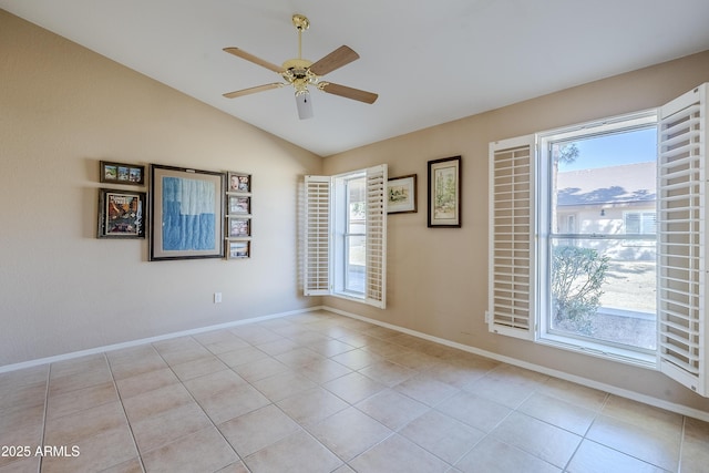 tiled empty room with lofted ceiling and ceiling fan