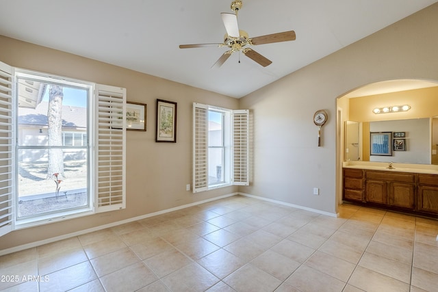 interior space featuring lofted ceiling, sink, and ceiling fan