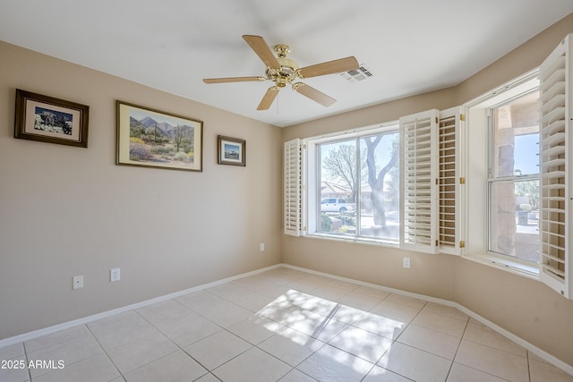 empty room with light tile patterned floors and ceiling fan