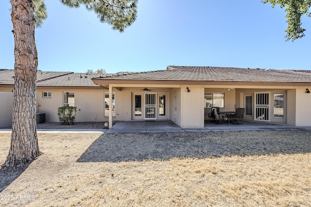 back of property featuring ceiling fan and a patio area