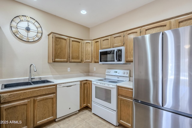 kitchen featuring stainless steel appliances, sink, and light tile patterned floors