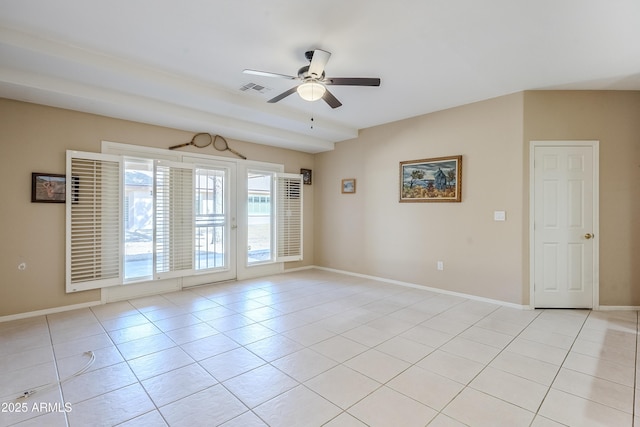 tiled spare room featuring ceiling fan