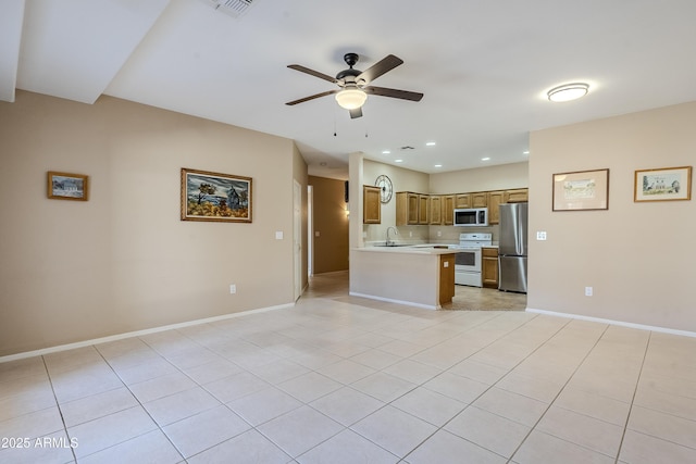 kitchen with appliances with stainless steel finishes, sink, light tile patterned floors, and ceiling fan